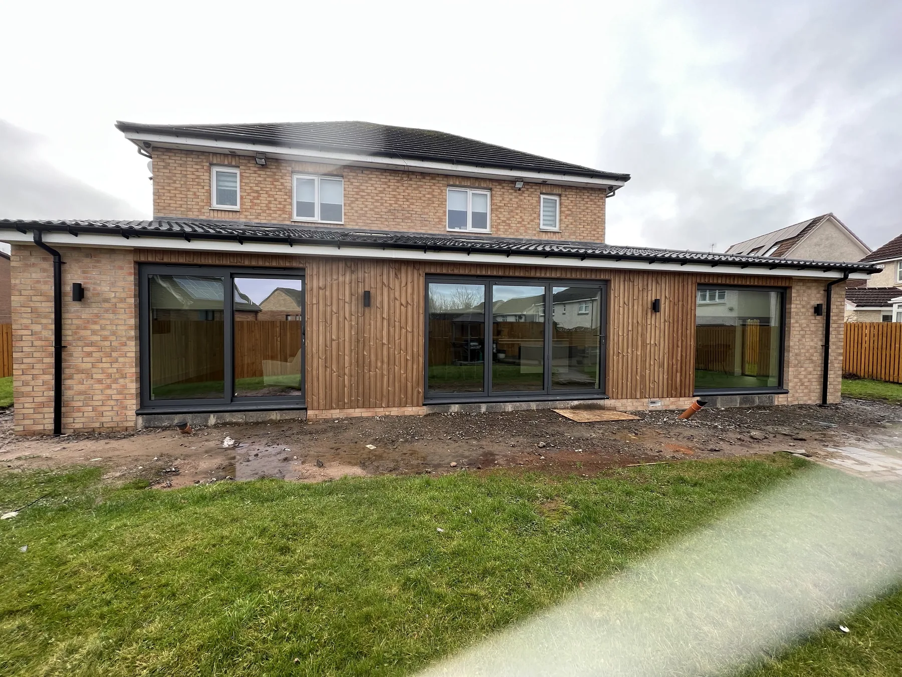 Brick rear extension with dark framed glazed doors