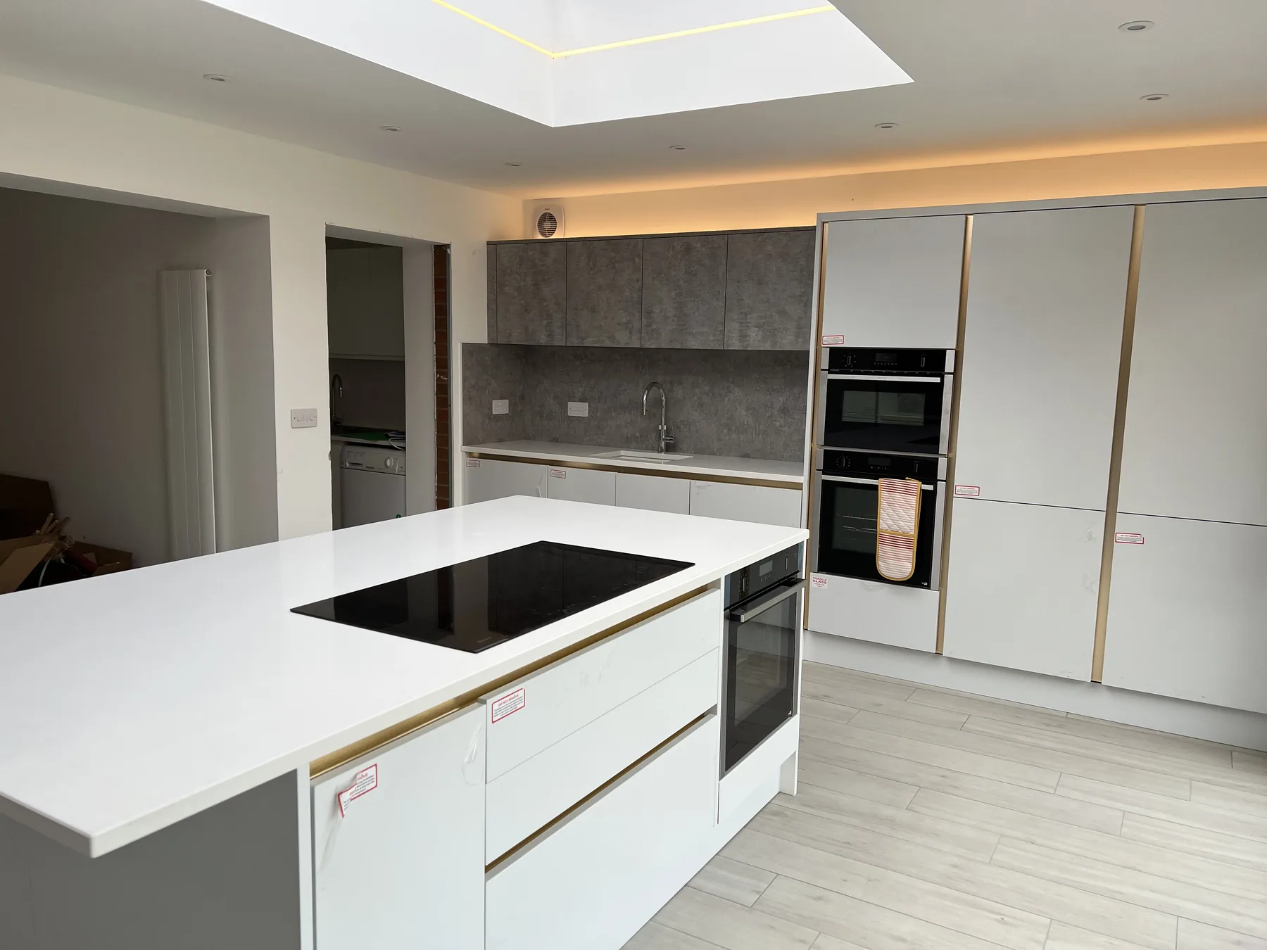 Contemporary kitchen with white island and fitted cabinetry.